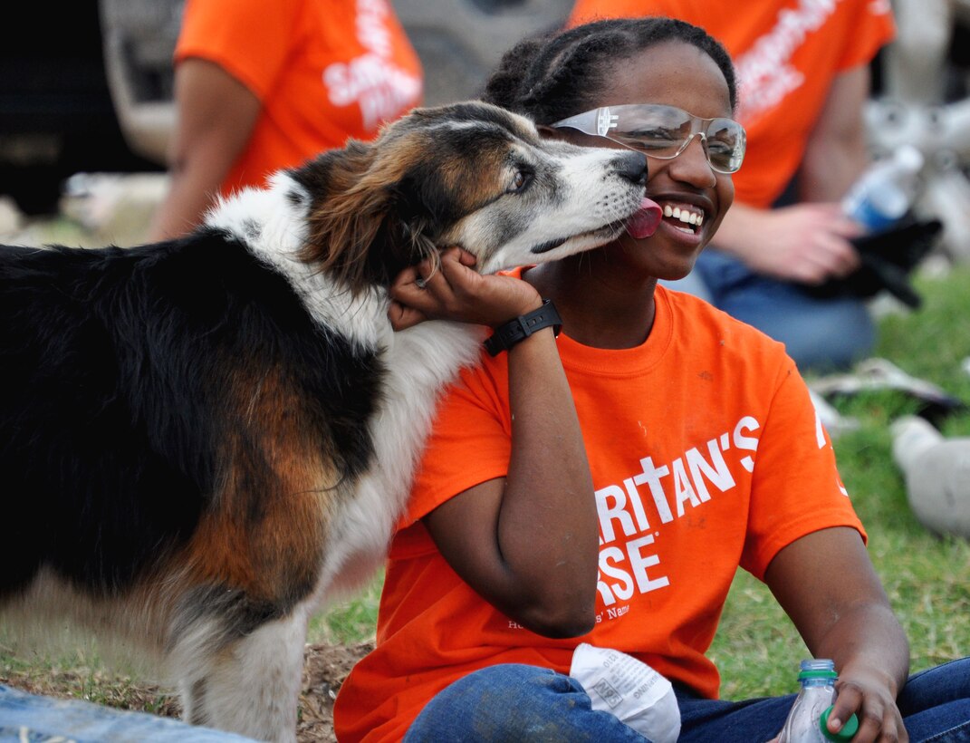 June 8, Airmen 1st Class Lisa Uku, 364th Training Squadron, Sheppard AFB, Texas, enjoys the company of “Twister” the dog found wandering among the rubble of what used to be a thriving neighborhood before the EF-5 (Enhanced Fujita Scale) tornado tore through Moore, Okla. May 20. The tornado gained EF-4 intensity within ten minutes of touching down north of Newtown Okla. Uku, in training for Hydraulics, is from Haledon, NJ. (U.S. Air Force photo/Kimberly Goff /Released)