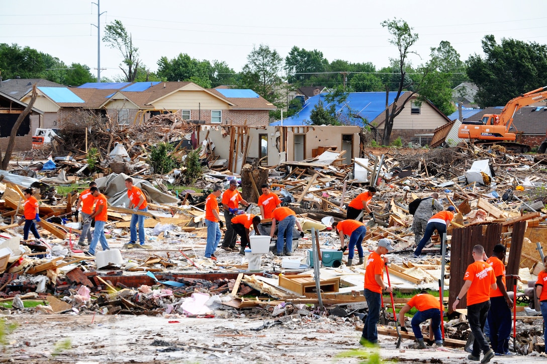 A group of airmen volunteers from Sheppard Air Force Base, Texas, work with Samaritan’s Purse to clear the rubble from the foundation of what used to be house June 8, 2013. The foundation is all that remains after an EF-5 (Enhanced Fujita Scale) tornado tore through Moore, Okla. May 20. The tornado destroyed Briarwood Elementary School and Plaza Towers Elementary School. (U.S. Air Force photo/Kimberly Goff /Released)