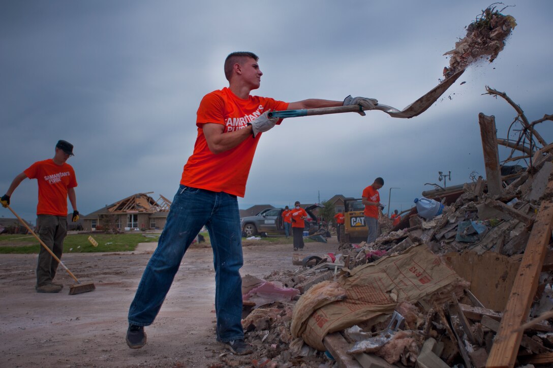 Airman 1st Class Anthony Webber, 365th Training Squadron, Sheppard Air Force Base, Texas, shovels debris into a pile June 8 in Moore, Okla. An EF-5 (Enhanced Fujita scale rating) tornado ripped through the central Oklahoma town May 20 with winds in excess of 210 mph winds. The twister was reportedly on the ground for 39 minutes and carved a path through neighborhoods for more than 17 miles. Webber, in training for CV-22 Osprey avionics, was among 70 Airmen who volunteered to clean up debris. He said, “This is why we joined the Air Force, to serve people.” (U.S. Air Force photo/Staff Sgt. Mike Meares/Released)