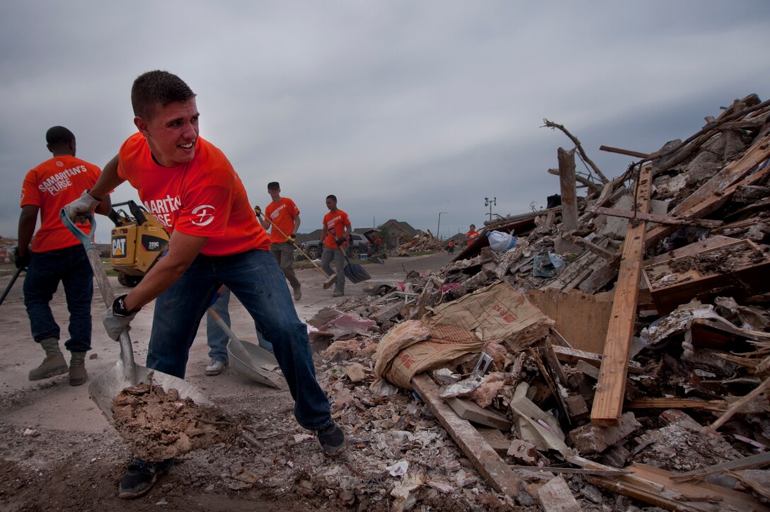 Airman 1st Class Anthony Webber, 365th Training Squadron, Sheppard Air Force Base, Texas, shovels debris into a pile June 8 in Moore, Okla. An EF-5 (Enhanced Fujita scale rating) tornado ripped through the central Oklahoma town May 20 with winds in excess of 210 mph winds. The twister was reportedly on the ground for 39 minutes and carved a path through neighborhoods for more than 17 miles. Webber, in training for CV-22 Osprey avionics, was among 70 Airmen who volunteered to clean up debris. He said, “This is why we joined the Air Force, to serve people.” (U.S. Air Force photo/Staff Sgt. Mike Meares/Released)