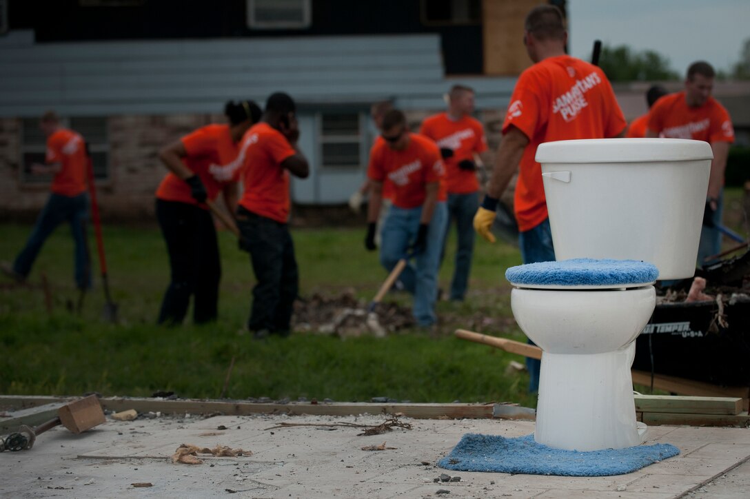 A toilet is the only thing that survived a damaging tornado at a house in Moore Okla., where Airmen from Sheppard Air Force Base, Texas, help clean up debris during a chapel sponsored trip. An EF-5 (Enhanced Fujita scale rating) tornado ripped through the central Oklahoma town May 20 with winds in excess of 210 mph winds. The twister was reportedly on the ground for 39 minutes and carved a path through neighborhoods for more than 17 miles. (U.S. Air Force photo/Staff Sgt. Mike Meares/Released)