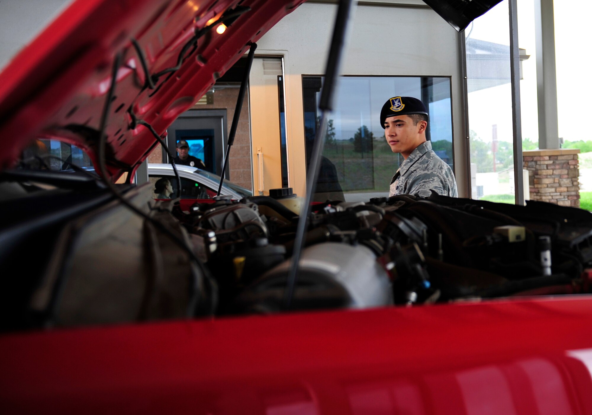 Senior Airman Michael Ngo, 460th Security Forces Squadron, searches a commercial vehicle June 5, 2013, at the Mississippi Gate on Buckley Air Force Base, Colo. In order for any commercial vehicle to gain access to a military installation, there must be a detailed vehicle search. Ngo’s daily duties are to secure the gates, inspect commercial vehicles that enter the base, relay information from the driver such as license, registration and work orders, and also verify if individuals can gain access to the installation. (U.S. Air Force photo by Airman 1st Class Darryl Bolden Jr./Released)