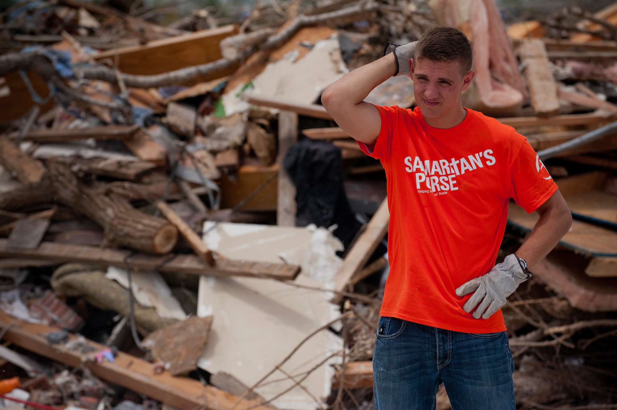Airman 1st Class Anthony Webber, 365th Training Squadron, Sheppard Air Force Base, Texas, take a moment June 8 to survey the damage path cut by a tornado in Moore, Okla. An EF-5 (Enhanced Fujita scale rating) tornado ripped through the central Oklahoma town May 20 with winds in excess of 210 mph winds. The twister was reportedly on the ground for 39 minutes and carved a path through neighborhoods for more than 17 miles. Webber, in training for CV-22 Osprey avionics, said, “This is why we joined the Air Force, to serve people.” (U.S. Air Force photo/Staff Sgt. Mike Meares/Released)