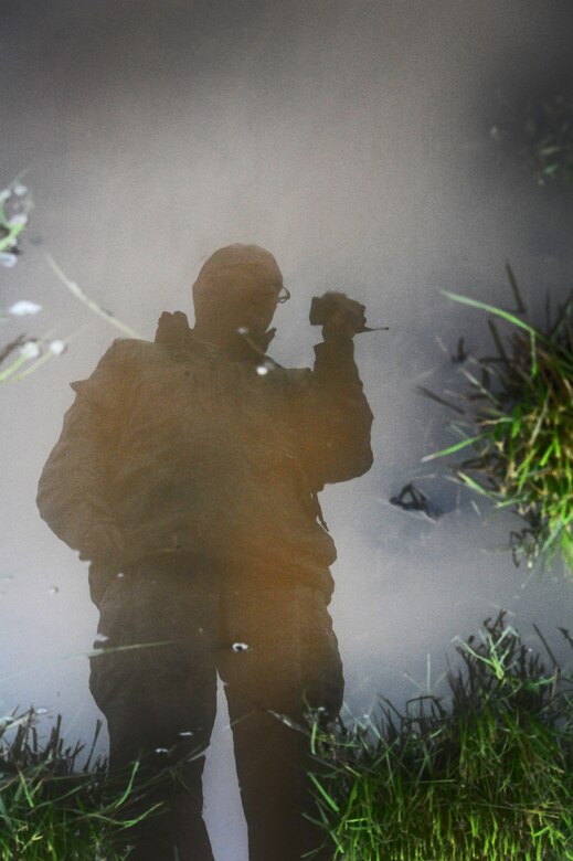 Staff Sgt. Timothy Cole, 509th Operations Support Squadron airfield management operations supervisor, calls in the status of rainwater on the flightline during a daily safety inspection at Whiteman Air Force Base, Mo., May 31, 2013. Airfield managers complete these inspections a minimum of 12 times a day to ensure complete airfield safety. (U.S. Air Force photo by Staff Sgt. Nick Wilson/Released)