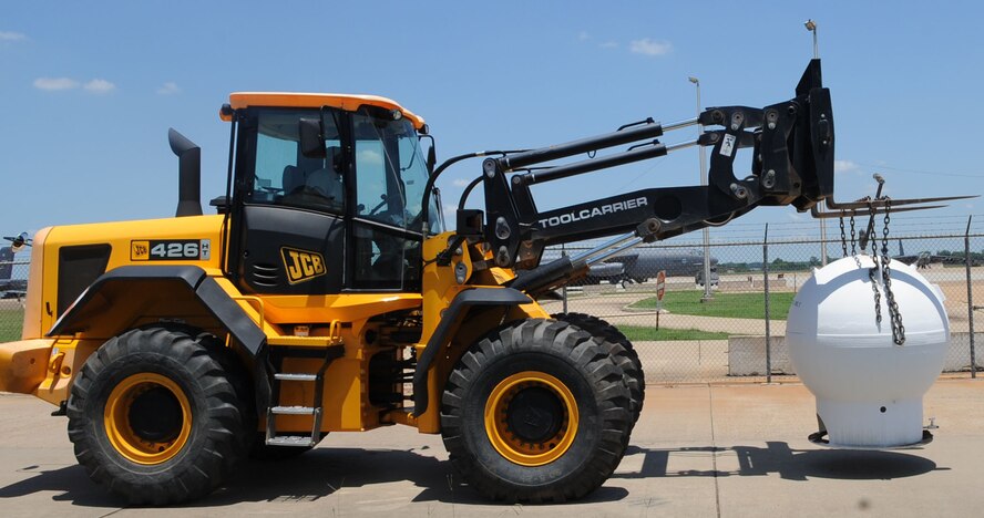 Staff Sgt. Jody Branson, from the 2nd Civil Engineer Squadron Heavy Repair section, moves a compressed natural gas pump on Barksdale Air Force Base, La., June 10, 2013. The gas pumps, outdated and no longer being used, will be brought to the Defense Reutilization and Marketing Office for proper disposal. (U.S. Air Force photo/Senior Airman Kristin High)