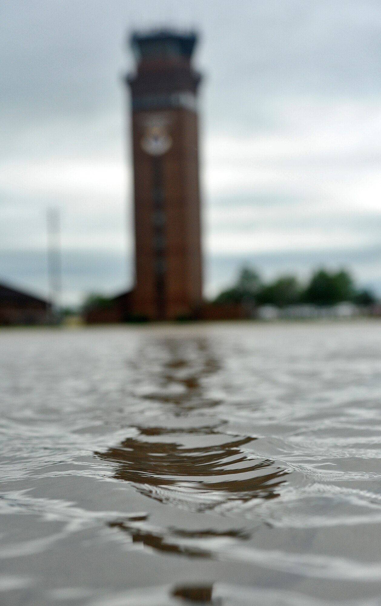 Moving rainwater builds up on the flightline after a rainstorm at Whiteman Air Force Base, Mo., May 31, 2013. Following such build-ups, airfield managers from the 509th Operations Support Squadron take assessments and close areas that could pose a threat to the safety of pilots and Airmen driving on the flightline. (U.S. Air Force photo by Staff Sgt. Nick Wilson/Released)