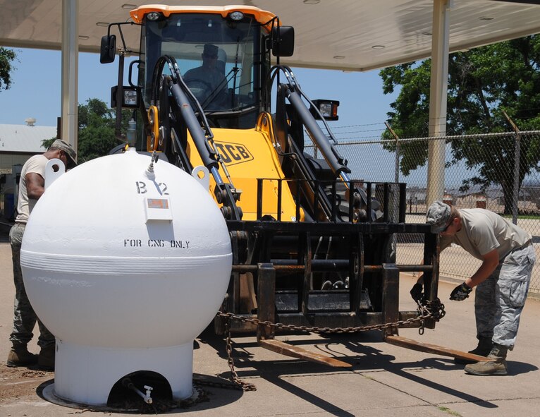2nd Civil Engineer Squadron Heavy Repair Airmen, prepare to move a compressed natural gas pump on Barksdale Air Force Base, La., June 10, 2013. The gas pumps, outdated and no longer being used, will be brought to the Defense Reutilization and Marketing Office for proper disposal. (U.S. Air Force photo/Senior Airman Kristin High)