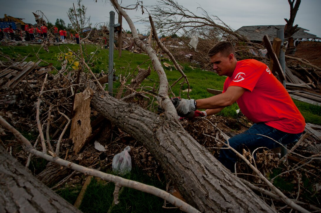 Airman 1st Class Anthony Webber, 365th Training Squadron, Sheppard Air Force Base, Texas, cuts though debris using a saws-all during debris clean-up June 8 in Moore, Okla. An EF-5 (Enhanced Fujita scale rating) tornado ripped through the central Oklahoma town May 20 with winds in excess of 210 mph winds. The twister was reportedly on the ground for 39 minutes and carved a path through neighborhoods for more than 17 miles. Webber is in training for avionics on the CV-22 Osprey and is from Spokane, Wa. (U.S. Air Force photo/Staff Sgt. Mike Meares/Released)