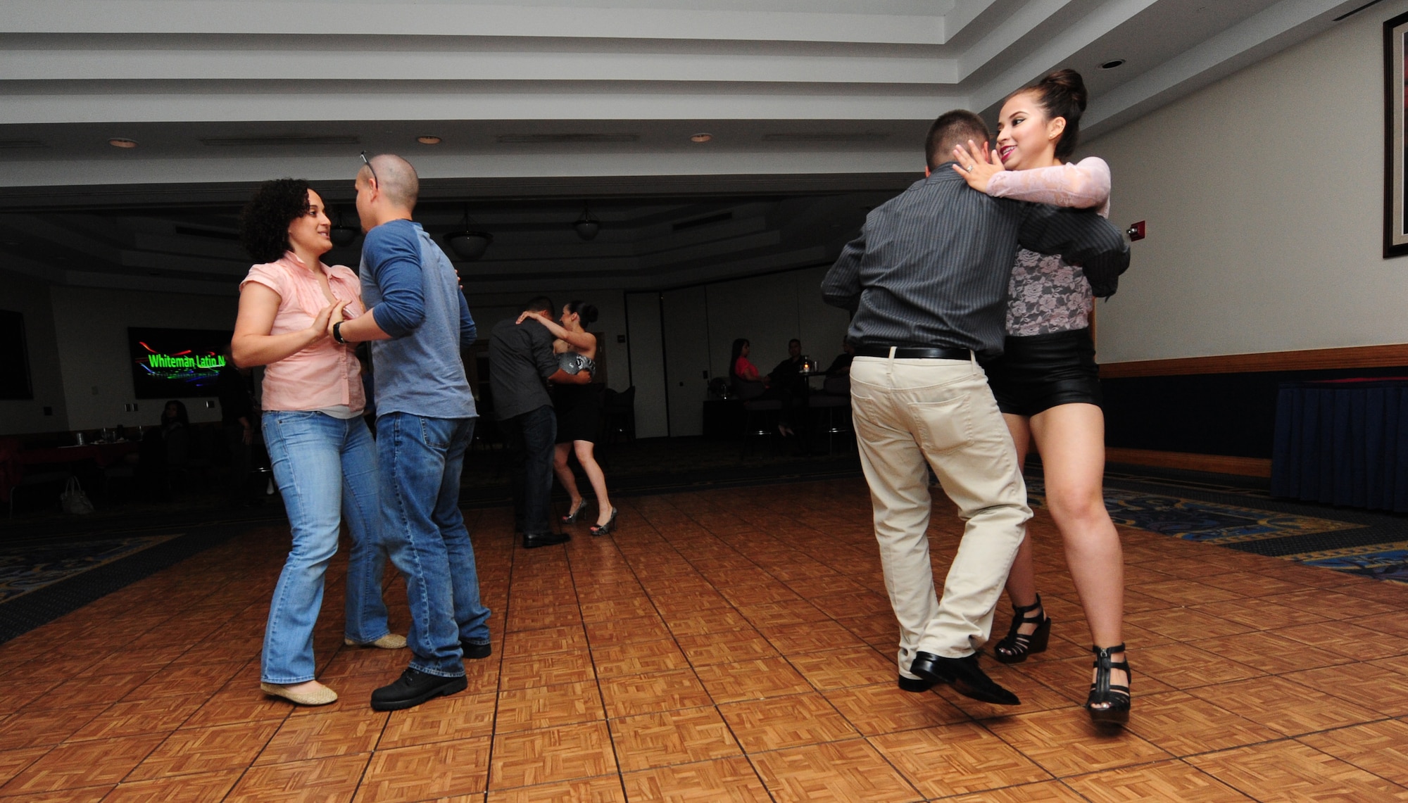 Airmen and spouses dance during Latin Night at Whiteman Air Force Base, Mo., June 1, 2013. The night’s events included free dance lessons, buffet-style appetizers, a disc jockey, live entertainment and karaoke. (U.S. Air Force photo by Staff Sgt. Nick Wilson/Released) 
