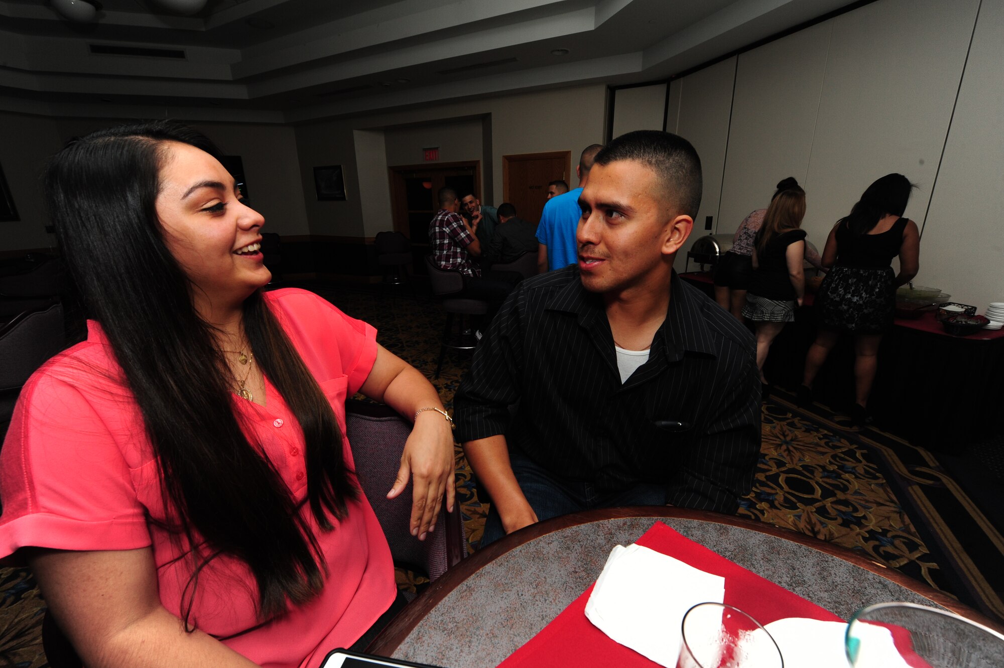 Jessica Lucio laughs as her husband, Staff Sgt. Antonio Lucio, 509th Logistics Readiness Squadron fuels specialist, tells a joke during Latin Night at Whiteman Air Force Base, Mo., June 1, 2013. The event included buffet-style appetizers, a disc jockey, live entertainment and karaoke. (U.S. Air Force photo by Staff Sgt. Nick Wilson/Released)