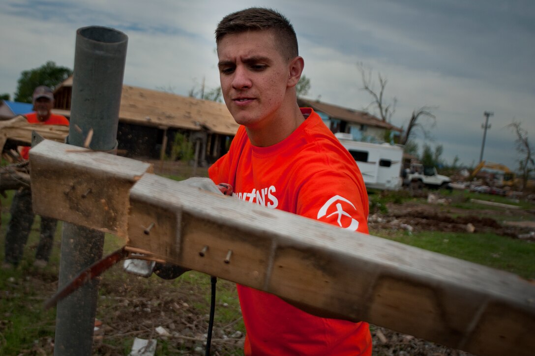 Airman 1st Class Anthony Webber, 365th Training Squadron, Sheppard Air Force Base, Texas, cuts though debris using a saws-all during debris clean-up June 8 in Moore, Okla. An EF-5 (Enhanced Fujita scale rating) tornado ripped through the central Oklahoma town May 20 with winds in excess of 210 mph winds. The twister was reportedly on the ground for 39 minutes and carved a path through neighborhoods for more than 17 miles. Webber is in training for avionics on the CV-22 Osprey and is from Spokane, Wa. (U.S. Air Force photo/Staff Sgt. Mike Meares/Released)