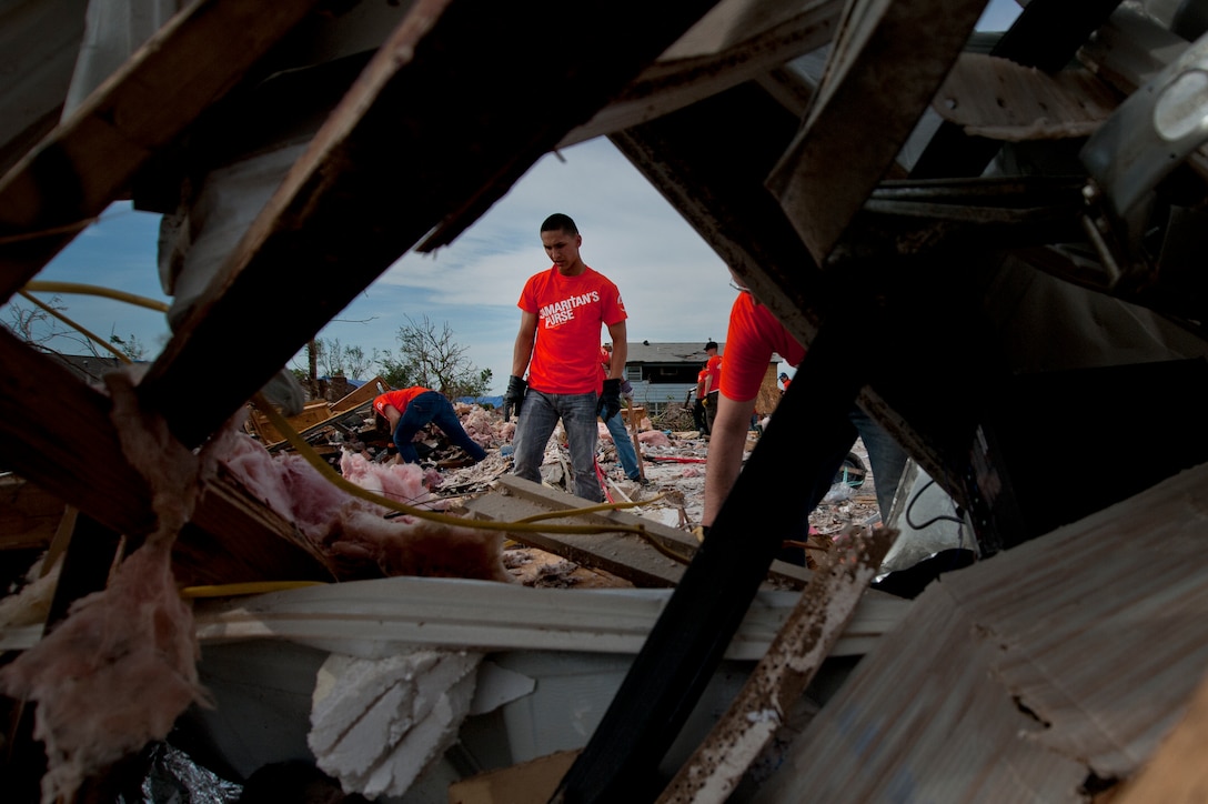 Airman Basic Zach Manzella, 363rd Training Squadron, Sheppard Air Force Base, Texas, helps clean up debris left by a tornado in Moore, Okla., June 8, during a chapel sponsored event. The EF-5 (Enhanced Fujita scale rating) tornado that struck May 20 caused an estimated $2 billion in damage. In all, somewhere between 12,000 and 13,000 homes were destroyed. Manzella’s hometown is Kent, Ohio. (U.S. Air Force photo/Staff Sgt. Mike Meares/Released)