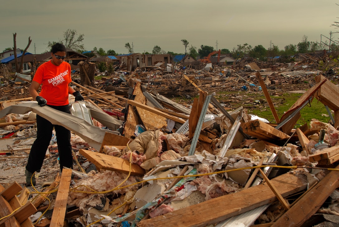 An Airman from Sheppard Air Force Base, Texas, clean up debris during a chapel sponsored trip to Moore, Okla., June 8. An EF-5 (Enhanced Fujita scale rating) tornado ripped through the central Oklahoma town May 20 with winds in excess of 210 mph winds. The twister killed 23, including seven children at Plaza Towers Elementary School, and injured 377. (U.S. Air Force photo/Staff Sgt. Mike Meares/Released)