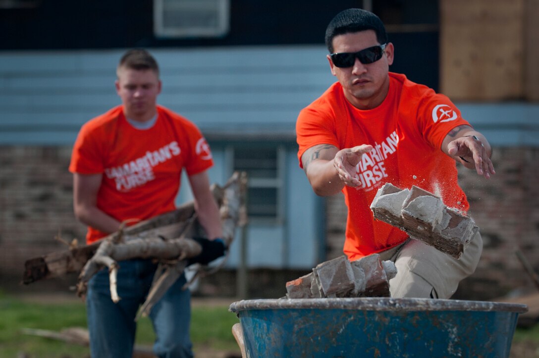Airmen in Training from Sheppard Air Force Base, Texas, clean up debris during a chapel sponsored trip to Moore, Okla., June 8. An EF-5 (Enhanced Fujita scale rating) tornado ripped through the central Oklahoma town May 20 with winds in excess of 210 mph winds. The twister was reportedly on the ground for 39 minutes and carved a path through neighborhoods for more than 17 miles. (U.S. Air Force photo/Staff Sgt. Mike Meares/Released)