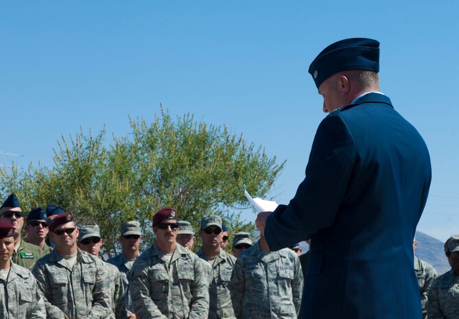Lt. Col. Daniel Duffy, 66th Rescue Squadron commander, addresses Airmen and family members at the PEDRO 66 street dedication ceremony June 10, 2013, at Nellis Air Force Base, Nev. Members of the 58th and 66th Rescue Squadrons joined the families of Nellis Airmen who were killed on June 9, 2010, when their helicopter was shot down and crashed in Helmand Province, Afghanistan. (U.S. Air Force photo by Airman 1st Class Joshua Kleinholz)