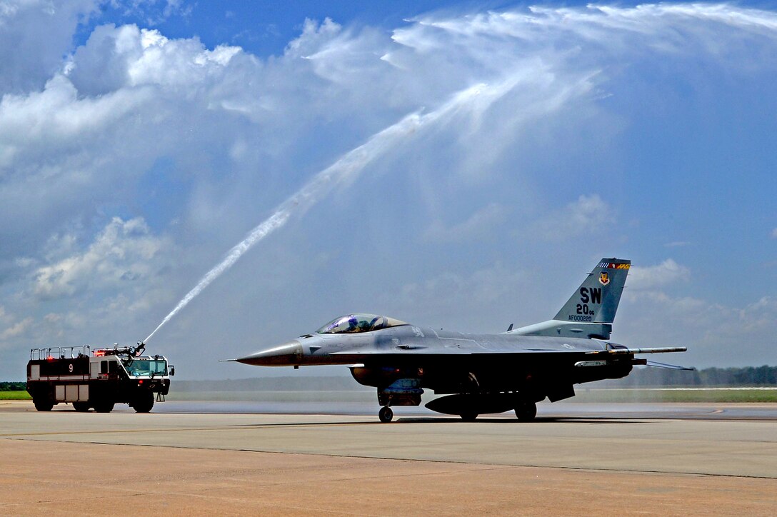 U.S. Air Force Col. Lance Kildron, 20th Fighter Wing vice commander, gets sprayed by a fire truck as he taxies down the Shaw runway upon returning from his final flight, June 11, 2013, Shaw Air Force Base S.C. Kildron served as the 20th FW vice commander for about a year and is now taking over as the Air Forces Central A3 Director at Al Udeid Air Base, Southwest Asia.  (U.S. Air Force photo by Airman 1st Class Nicole Sikorski/Released)