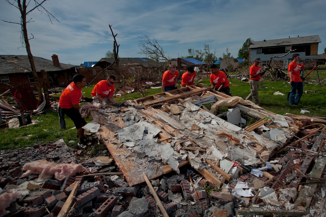 Airmen from Sheppard Air Force Base, Texas, clean up debris during a chapel sponsored trip to Moore, Okla., June 8. An EF-5 (Enhanced Fujita scale rating) tornado ripped through the central Oklahoma town May 20 with winds in excess of 210 mph winds. The twister was reportedly on the ground for 39 minutes and carved a path through neighborhoods for more than 17 miles. (U.S. Air Force photo/Staff Sgt. Mike Meares/Released)