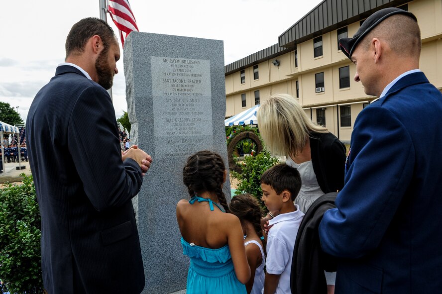 Family and friends of Maj. David Gray look at his name on the Tactical Air Control Party monument during a memorial ceremony at the TACP school on Hurlburt Field, Fla., June 6, 2013. TACP members remembered a fallen comrade during the annual TACP Association memorial and reunion. (U.S. Air Force photo/Airman 1st Class Christopher Callaway)