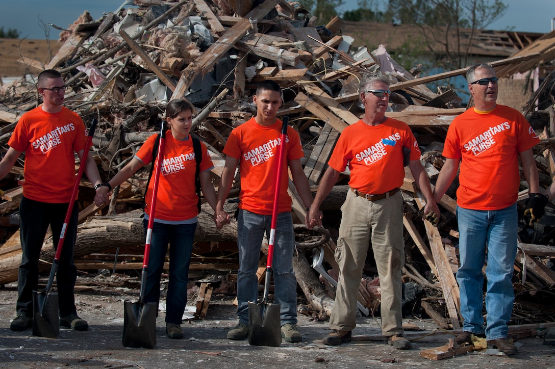Airmen from Sheppard Air Force Base, Texas, join hands and pray for the victims of the June 8 tornado in Moore, Okla. The Airmen drove the more than two-hour trip to help clean up debris during a chapel sponsored trip to. An EF-5 (Enhanced Fujita scale rating) tornado ripped through the central Oklahoma town May 20 with winds in excess of 210 mph winds. (U.S. Air Force photo/Staff Sgt. Mike Meares/Released)
