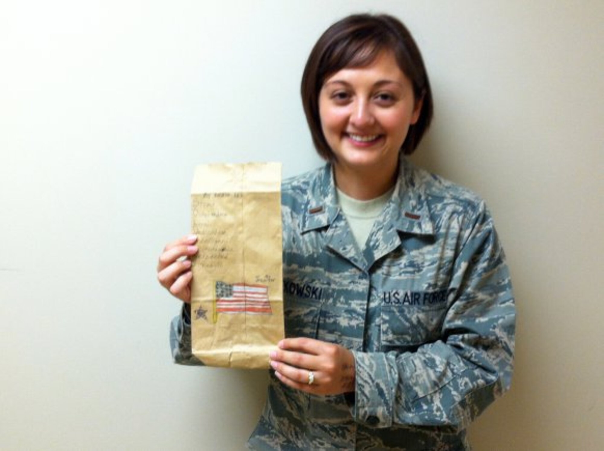 2nd Lt. Jennifer Szatkowski holds up a decorative brown bag she made for service members more than a decade ago while in grade school. Szatkowski, a second year medical student with the Uniformed Services University of the Health Sciences, saw the bag on a bulletin board where she was having her teeth cleaned. (Courtesy photo)