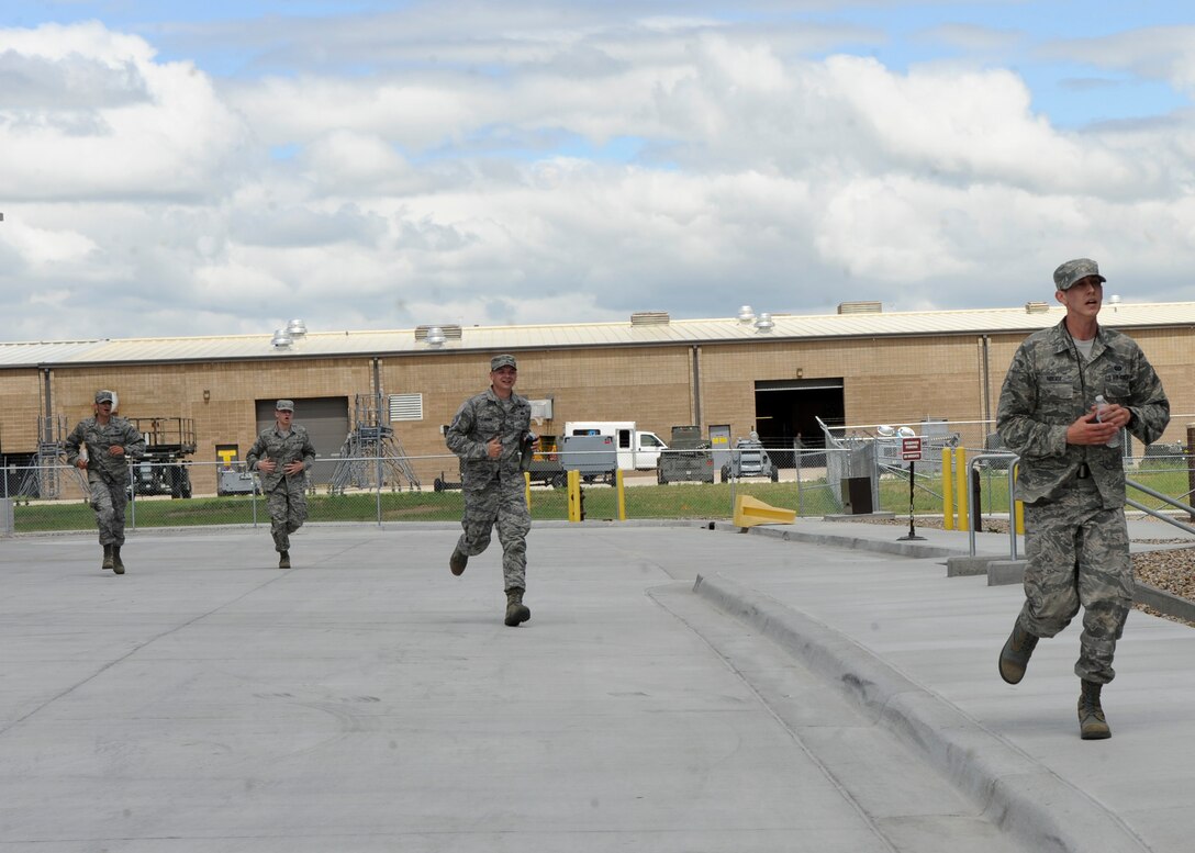 Team Reaper, comprised of members of the 432nd Attack Squadron, race to the finish point during the Warrior Challenge at Ellsworth Air Force Base, S.D., June 5, 2013. Twelve teams competed against one another in a timed challenge that tested participants combat readiness skills and helped promote a wingman culture. (U.S. Air Force photo by Airman 1st Class Anania Tekurio/Released)   