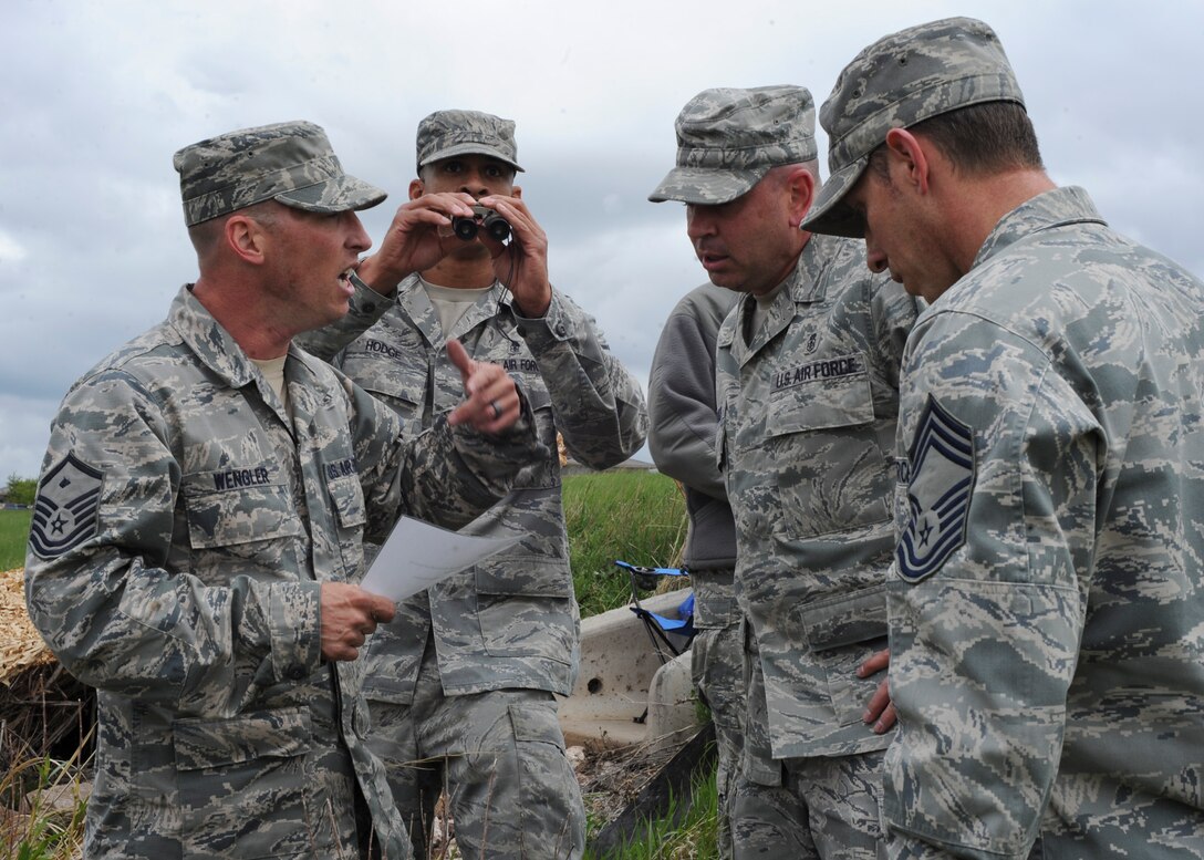 The Ageless Wonders team, consisting of four members of the 28th Medical Group, complete a size, activities, location, unit identification, time and date, and equipment report during the Warrior Challenge at Ellsworth Air Force Base, S.D., June 5, 2013. The Warrior Challenge was a 3-mile course where teams raced to complete several different obstacles comprised of simulated real-world combat situations. (U.S. Air Force photo by Airman 1st Class Anania Tekurio/Released)