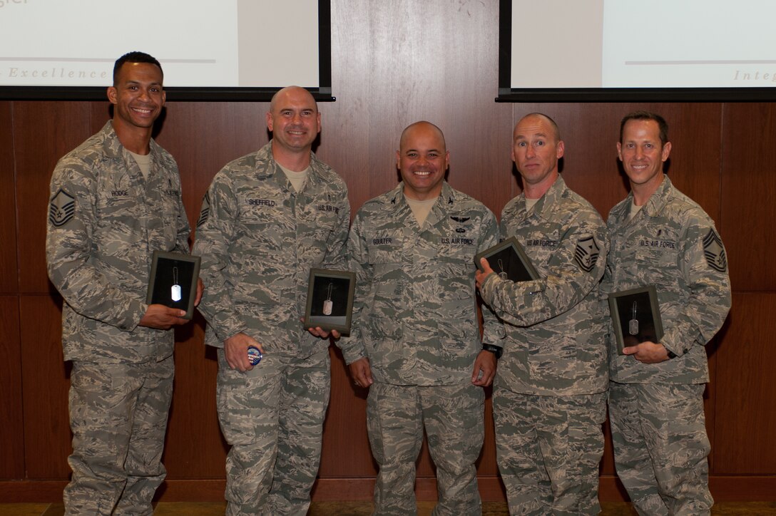 The Ageless Wonders team from the 28th Medical Group receives awards from Col. Thomas Goulter Jr., 28th Mission Support Group commander, after winning the Warrior Challenge at Ellsworth Air Force Base, S.D., June 5, 2013. The Ageless Wonders completed the course in 42 minutes and 10 seconds, the fastest time of the 12 teams that competed. (U.S. Air Force photo by Airman 1st Class Alystria Maurer/Released)