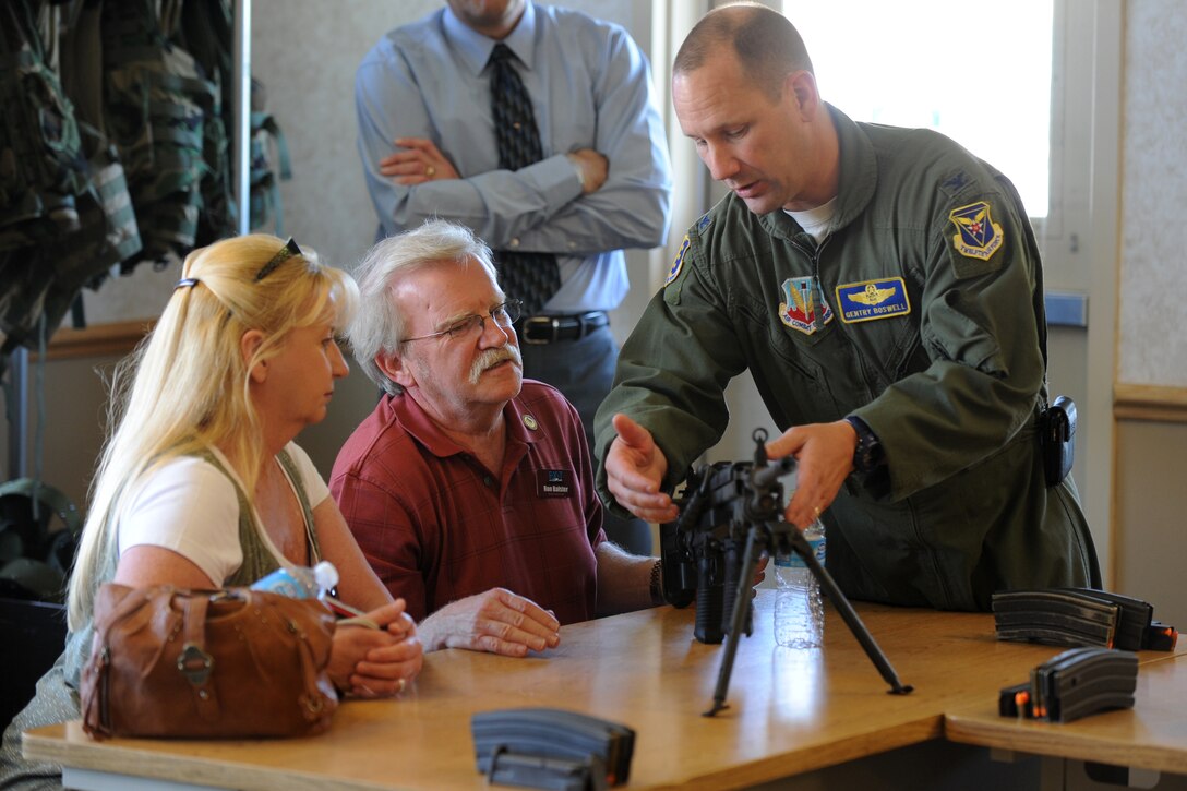 Col. Gentry Boswell, 28th Bomb Wing vice commander, explains the characteristics of an M-249 automatic rifle to Ron Balster, 28th Maintenance Squadron honorary commander, and his wife, Winnie, during a tour of 28th Security Forces Squadron facilities at Ellsworth Air Force Base, S.D., June 7, 2013. Nineteen community leaders enrolled in the 28th BW Honorary Commanders program teamed up with their base counterparts to experience a variety of security forces activities. (U.S. Air Force photo by Master Sgt. John Barton/Released) 