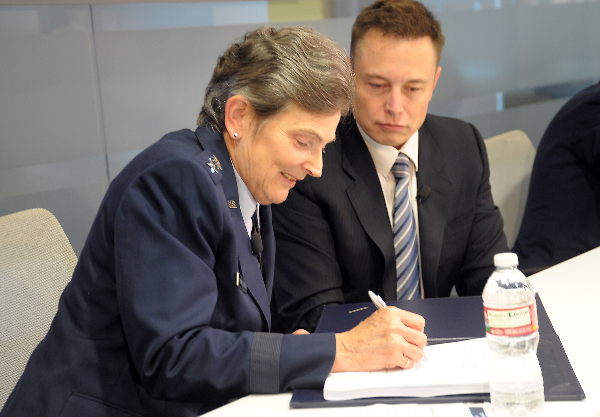 Lieutenant General Ellen Pawlikowski, SMC commander, and Elon Musk, SpaceX CEO, sign a Cooperative Research and Development Agreement to certify the Falcon 9 v1.1 Launch System for National Security Space missions at a ceremony, June 7. The CRADA will be in effect until all certification activities are complete. While certification does not guarantee a contract award, it does enable a company to compete for launch contracts. (Photo by Joe Juarez)