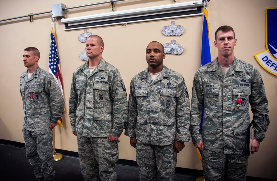 From left, U.S. Air Force Lt. Col. James Meier, and Master Sgts. Timothy Kaluza, Mandel Pickett and Richard Holder stand at attention during a Bronze Star Medal presentation ceremony at Moody Air Force Base, Ga., June 7, 2013. The Bronze Star Medal is the 10th highest award in the U.S. military. (U.S. Air Force photo by Senior Airman Jarrod Grammel/Released)

