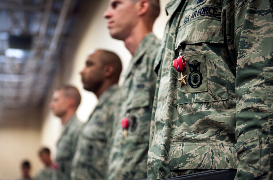 Bronze Star Medal recipients stand at attention during a presentation ceremony at Moody Air Force Base, Ga., June 7, 2013. All four Airmen were members of the 824th Base Defense Squadron and earned the medal while deployed to Afghanistan. (U.S. Air Force photo by Senior Airman Jarrod Grammel/Released)
