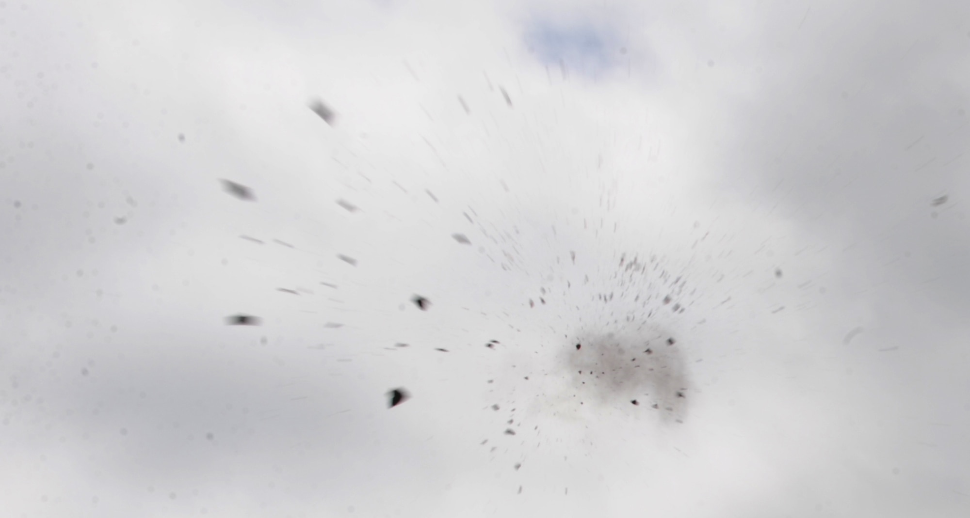 A clay pigeon shatters in mid-air after being hit by a participant at the Whiteman Air Force Base Skeet and Trap Range, May 22, 2013. Because the new targets are solar-powered, shooters do not need to sign out a battery for the throwers and drag cords throughout the range. (U.S. Air Force photo by Staff Sgt. Alexandra M. Boutte/Released)