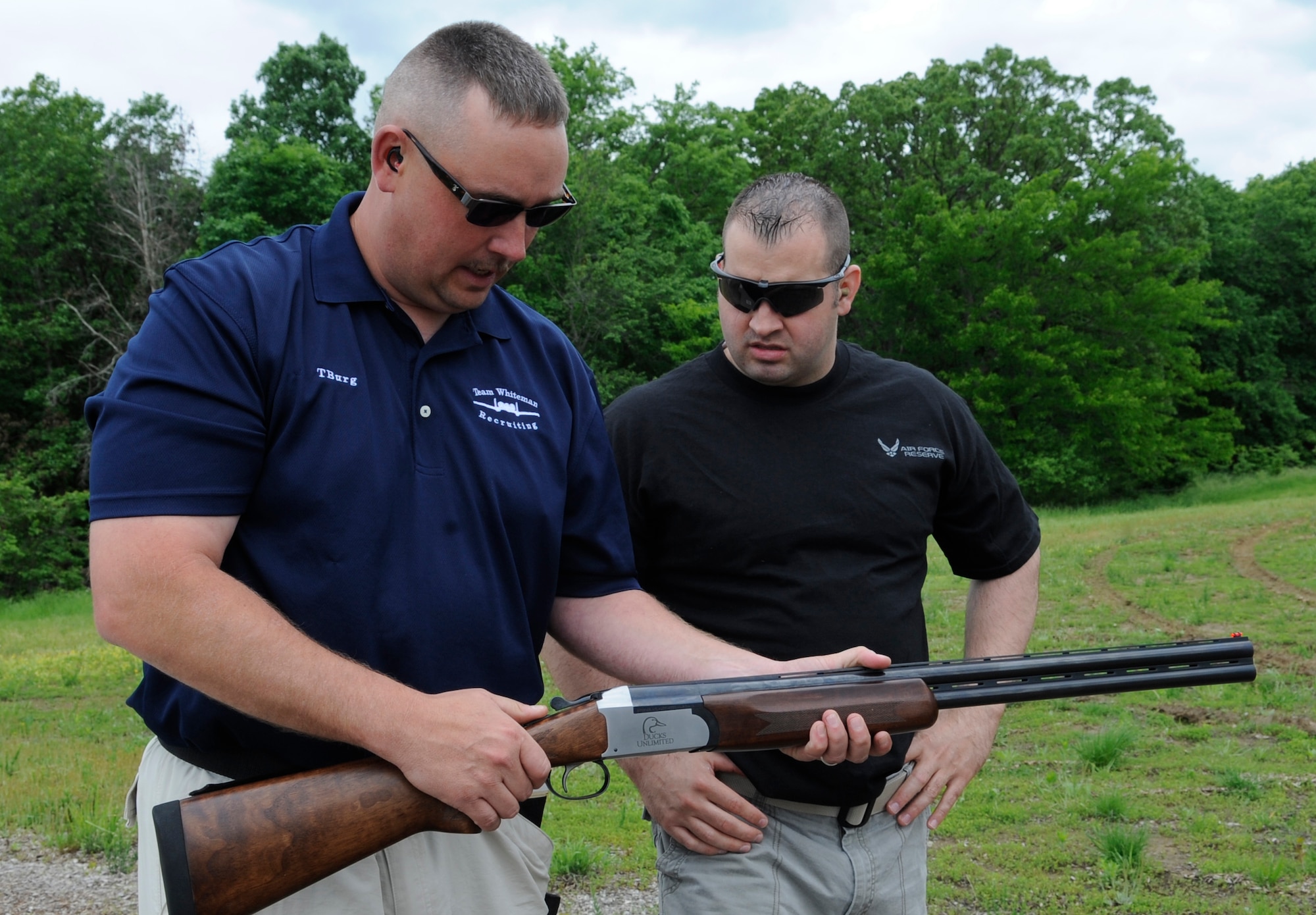 Senior Master Sgt. Frederick Transburg, Air Force Reserve recruiter, explains how to use a shotgun to Master Sgt. Christopher Modlin, Air Force Reserve recruiter, at the Whiteman Air Force Base Skeet and Trap Range, May 22, 2013.  Transburg has been skeet-shooting for about 10 years. (U.S. Air Force photo by Staff Sgt. Alexandra M. Boutte/Released)