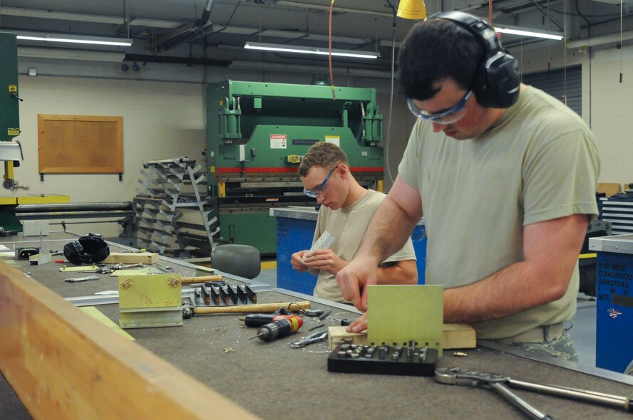 U.S. Air Force Airmen 1st Class Marshall Coffelt (right) and Bradyn Grardner, 139th Airlift Wing, structural maintenance, Missouri Air National Guard,  participate in a structural training project on June 8, 2013, at Rosecrans Air National Guard Base, Mo. (U.S. Air National Guard photo by Airman 1st Class Katherine Kelly/Released)