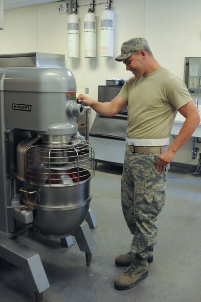 U.S. Air Force Senior Airman Jonathan Warner, 139th Services Flight, Missouri Air National Guard, operates a mixer on June 8, 2013, at Rosecrans Air National Guard Base, Mo. (U.S. Air National Guard photo by Airman 1st Class Katherine Kelly/Released)