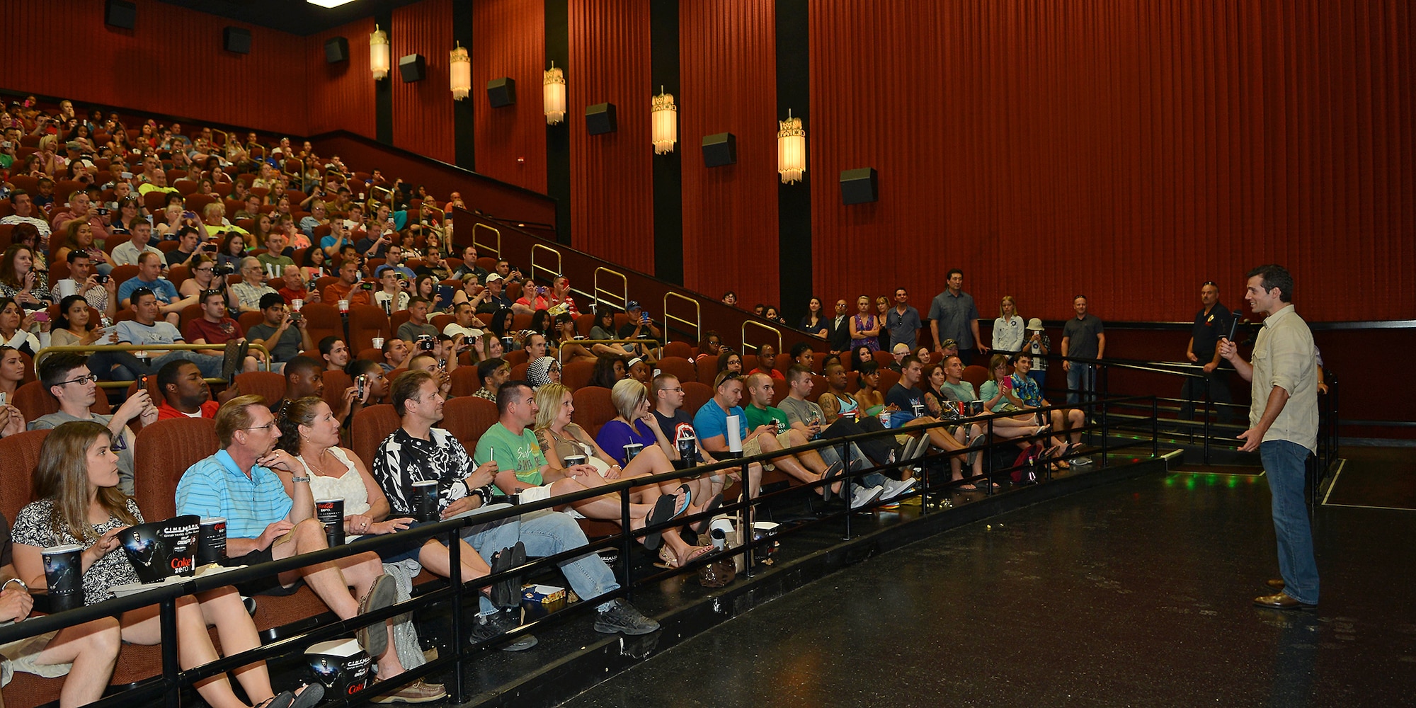 Henry Cavill speaks to Edwards AFB moviegoers before the prescreening of "Man of Steel." The movie was shown in two theaters June 8. The free showing was provided by Warner Bros. in appreciation for the help Edwards AFB provided during the filming of the movie early 2012. (U.S. Air Force photo by Jet Fabara)