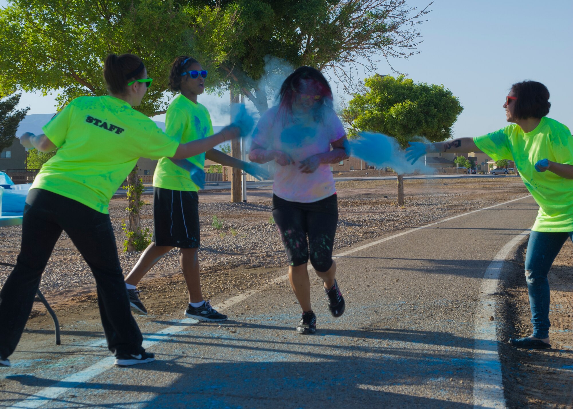 Members of Team Holloman are “blasted” with colored corn starch powder during the Art Blast run at Holloman Air Force Base, N.M., June 8. Over 200 people of all ages participated in this morale-boosting 5k run.  (U.S. Air Force photo by Airman 1st Class Aaron Montoya/Released)