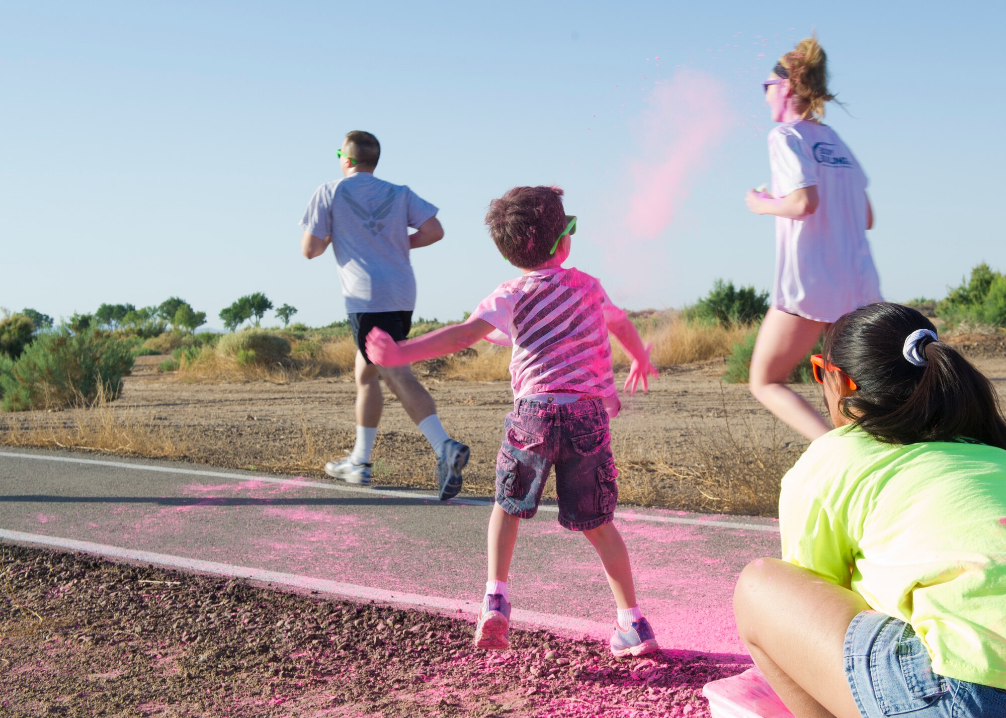 Members of Team Holloman are “blasted” with colored corn starch powder during the Art Blast run at Holloman Air Force Base, N.M., June 8. Over 200 people of all ages participated in this morale-boosting 5k run.  (U.S. Air Force photo by Airman 1st Class Aaron Montoya/Released)