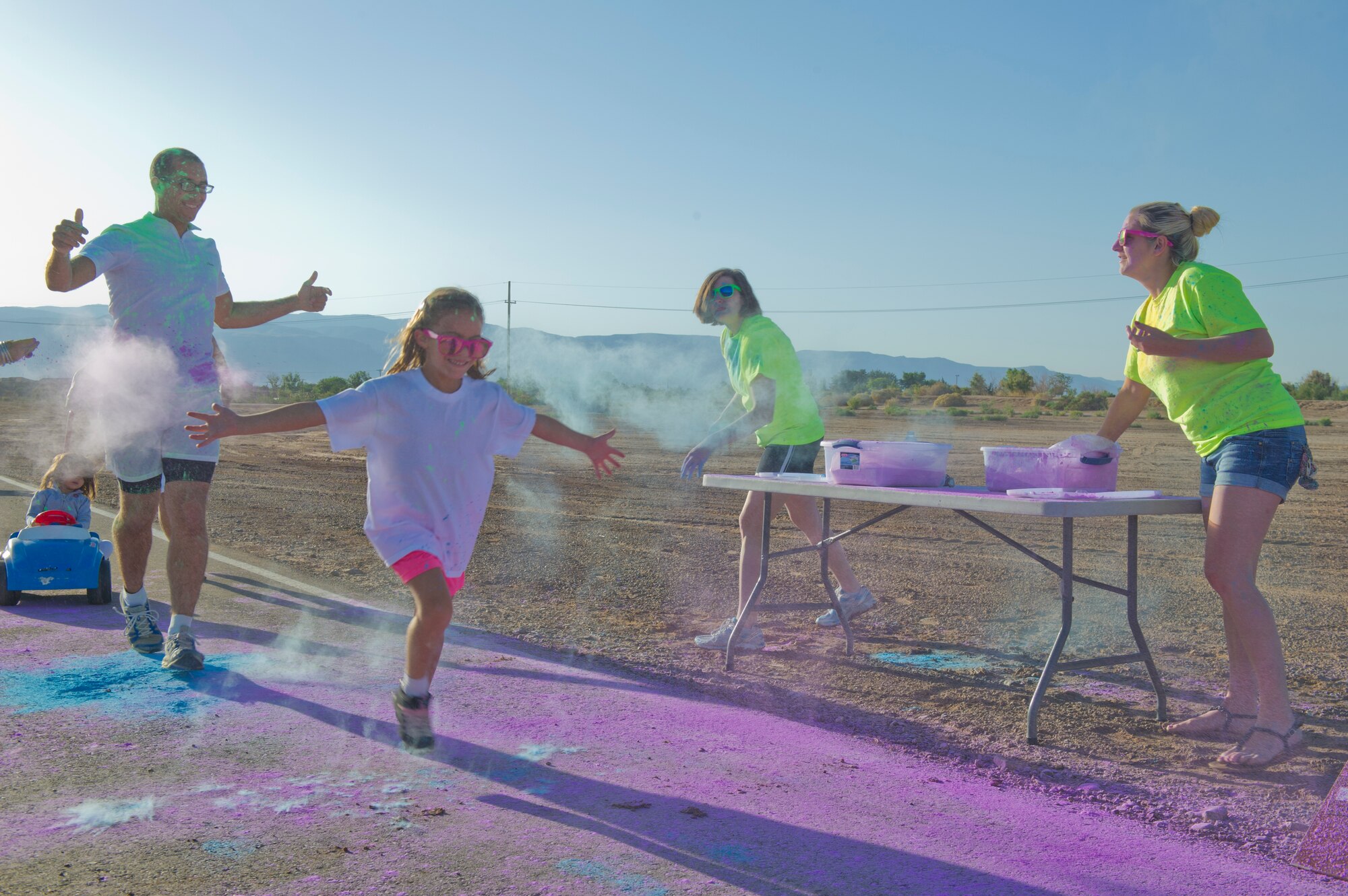 Members of Team Holloman are “blasted” with colored corn starch powder during the Art Blast run at Holloman Air Force Base, N.M., June 8. Over 200 people of all ages participated in this morale-boosting 5k run.  (U.S. Air Force photo by Airman 1st Class Aaron Montoya/Released)