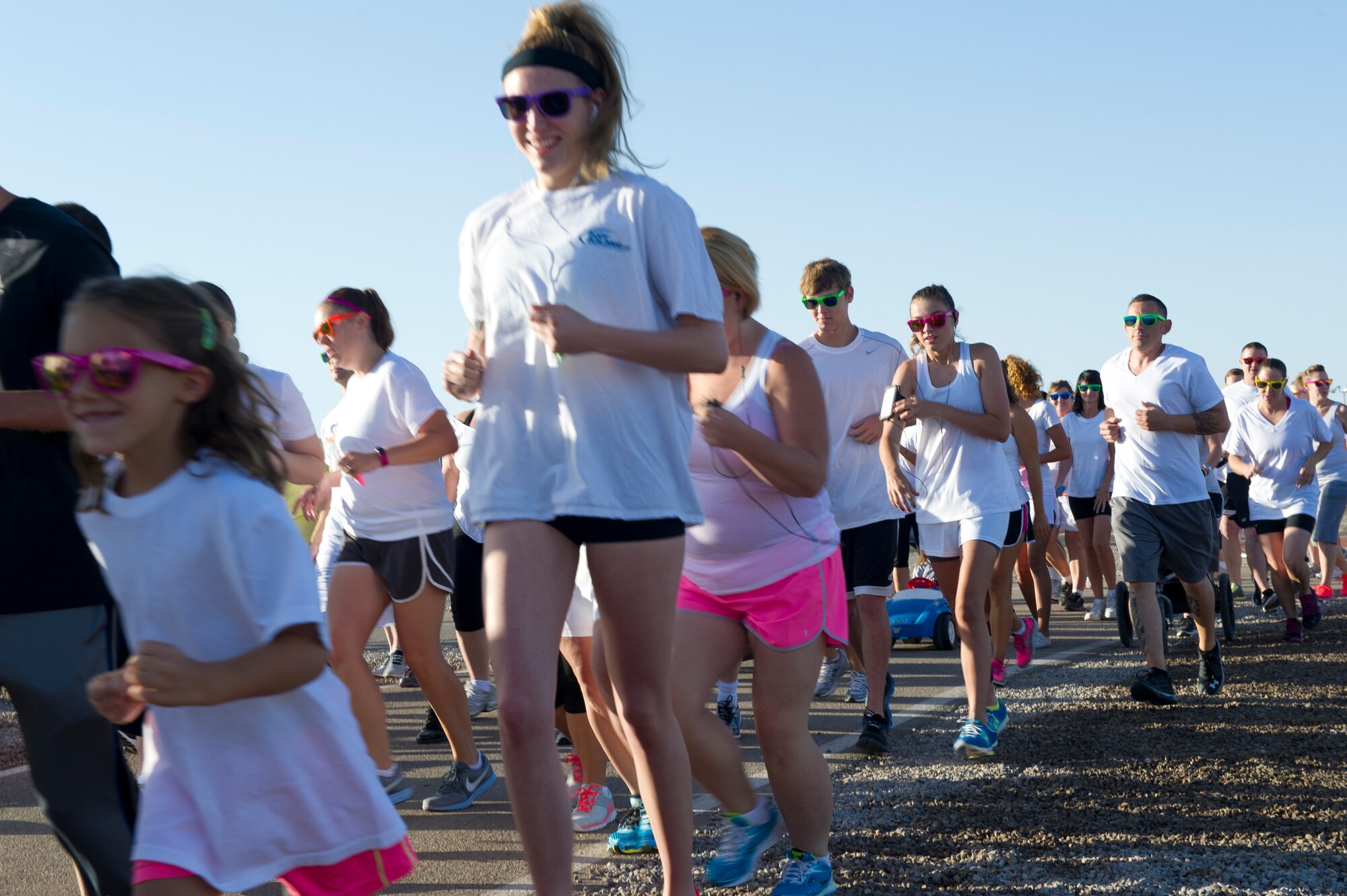 Members of Team Holloman take their first steps in the Art Blast 5k run at Holloman Air Force Base, N.M., June 8. The Art Blast run was a non-competitive event in which over 200 participants were showered with colored corn starch powder. (U.S. Air Force photo by Airman 1st Class Aaron Montoya/Released)