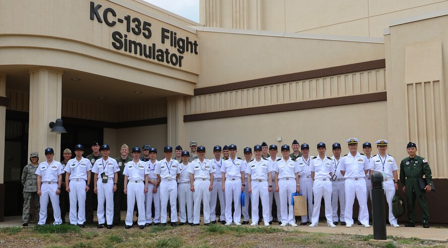 Japan Maritime Self Defense Force (JMSDF) P-3 crew members and Joint Base Pearl Harbor-Hickam personnel pose for a group photo in front of the KC-135 Stratotanker flight simulator at Joint Base Pearl Harbor-Hickam, Hawaii, June 7, 2013. The JMSDF crew members toured JBPHH as part of a bilateral event to increase relations between U.S. and Japanese service members. (U.S. Air Force photo/Tech. Sgt. Jerome S. Tayborn)