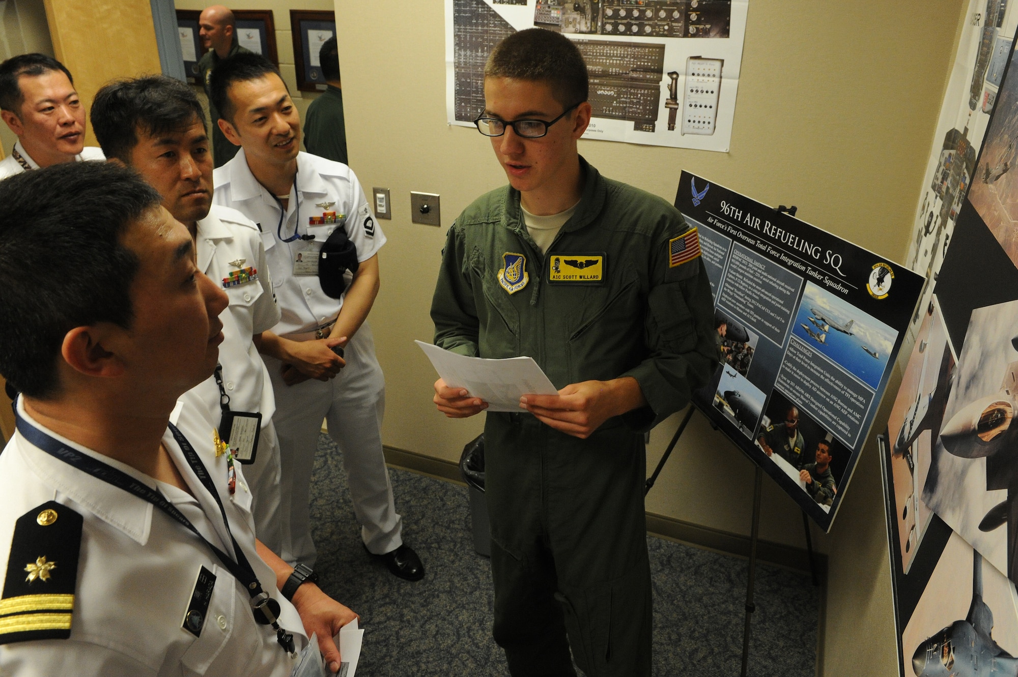 Airman 1st Class Scott Willard, 96th Air Refueling Squadron boom operator, right, gives a KC-135 Stratotanker introduction brief to Japan Maritime Self Defense Force (JMSDF) P-3 crew members during a tour at Joint Base Pearl Harbor Hickam, Hawaii June 7, 2013. The purpose and value of the training is to facilitate military interaction and for the JMSDF to have gained an operational understanding of the 96th ARS. (U.S. Air Force photo/Tech. Sgt. Jerome S. Tayborn)