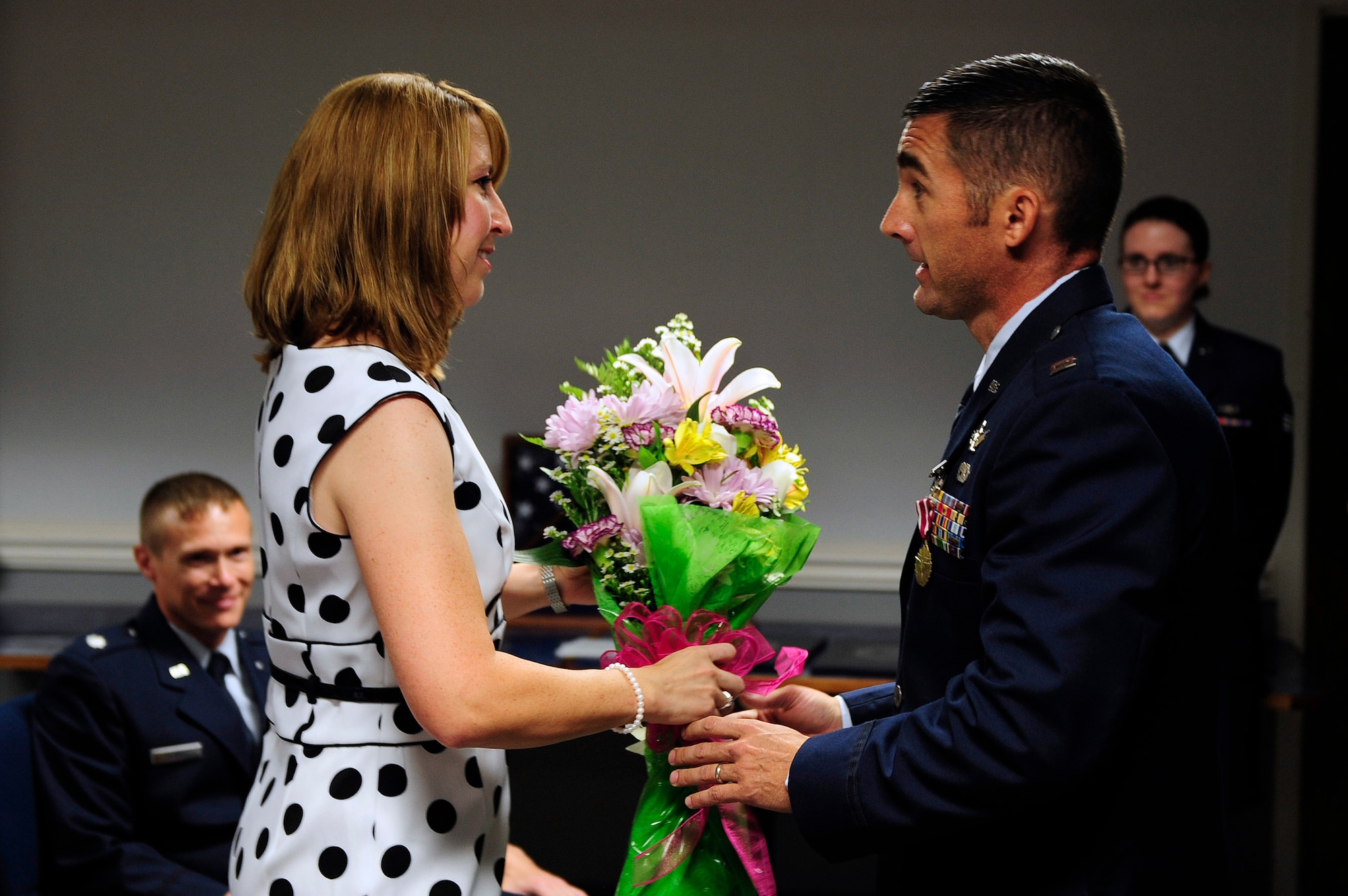 Capt. Christopher Snapp, Air Forces Central 609th Air Operations Center Detachment 1 operations flight commander, presents his wife Amanda with a bouquet of flowers during his retirement ceremony at Shaw Air Force Base, S.C., June 7, 2013. Snapp served from 1992 to 2013, and retired at the grade of captain. (U.S. Air Force photo by Airman 1st Class Daniel Blackwell/Released)