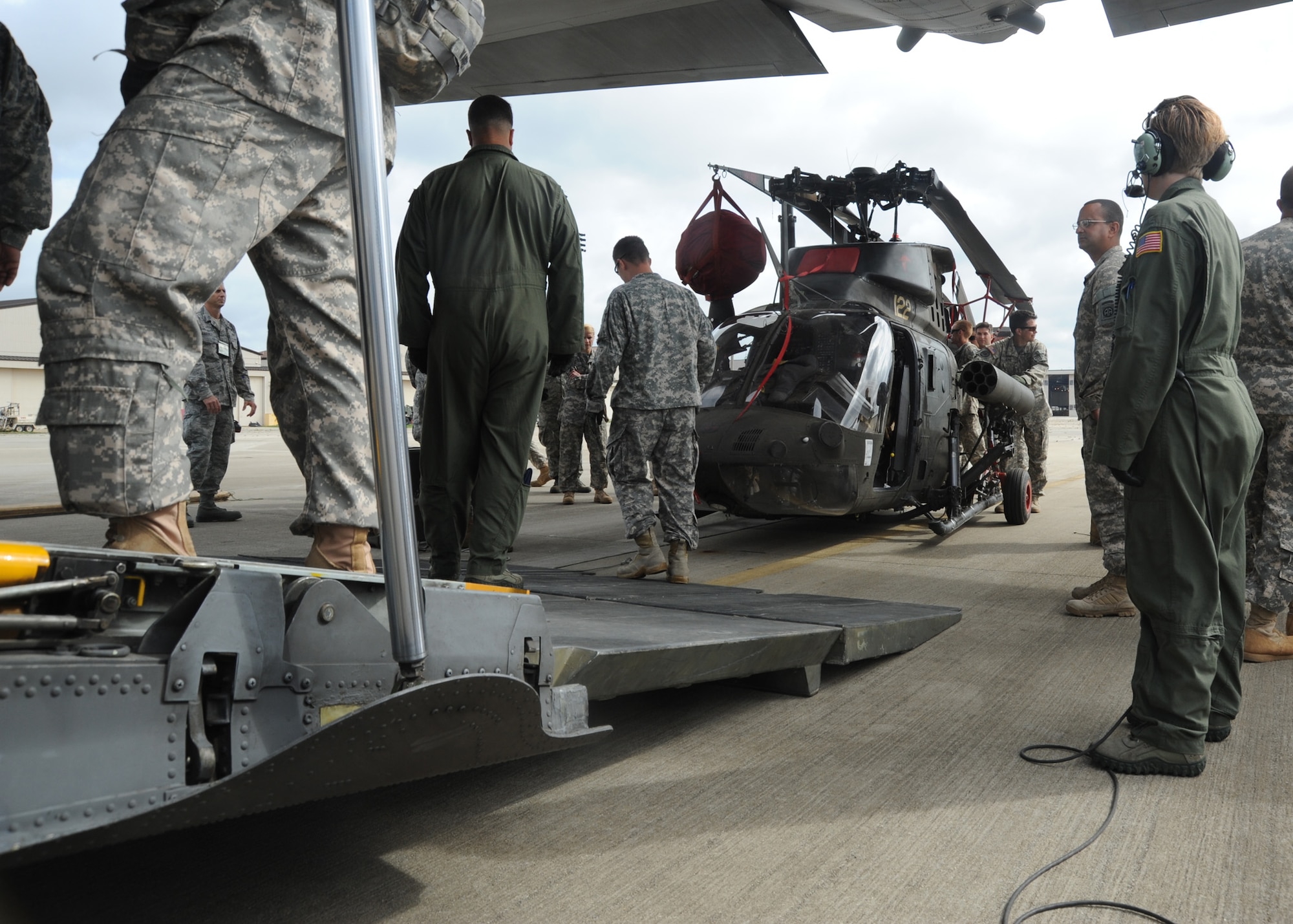 Soldiers with 1st Squadron, 17th Cavalry Regiment, Combat Aviation Brigade, load an OH-58D Kiowa Warrior armed reconnaissance helicopter into a C-130H medium transport aircraft at Pope Field, N.C., on June 2, 2013.  1st Squadron is the Air Cavalry Reconnaissance Squadron of the Combat Aviation Brigade, 82nd Airborne Division stationed at Fort Bragg, North Carolina.  (Air Force photo by Tech. Sgt. Peter R. Miller)