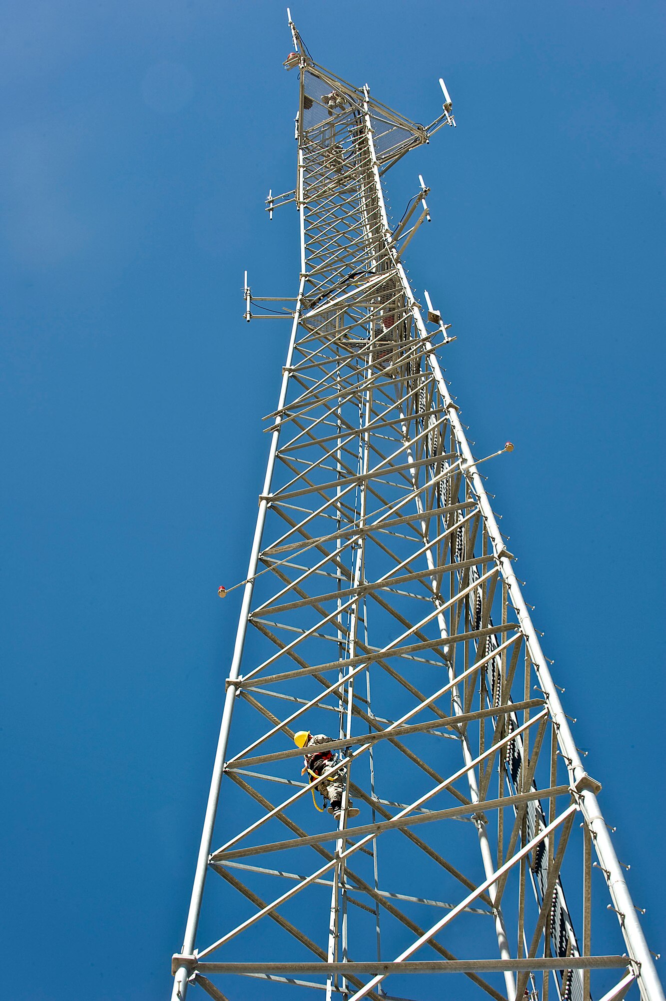 Col. Barry Cornish, 99th Air Base Wing commander, climbs the radio tower during the tower climbing demonstration June 7, 2013, at Nellis Air Force Base, Nev. The radio tower is more than 200 feet tall. (U.S. Air Force photo by Senior Airman Matthew Lancaster)