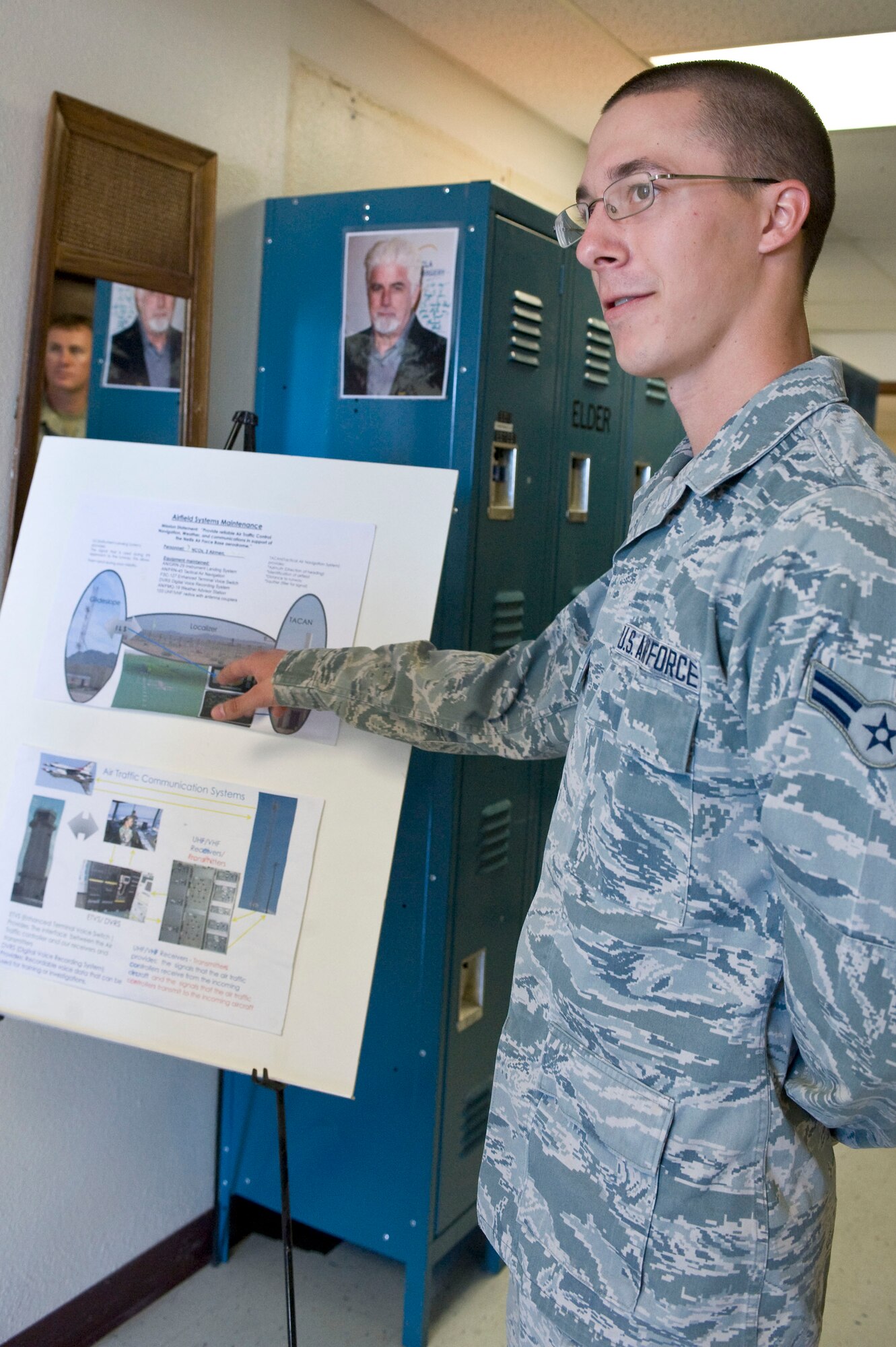 Airman 1st Class James Vrtis, 99th Communication Squadron airfield systems apprentice, briefs about different types of radio equipment before the radio tower climbing demonstration June 7, 2013, at Nellis Air Force Base, Nev. The 99th CS uses ultra-high and very high radios with antenna couplers. The UHF/VHF transmitters provide signals the air traffic controllers receive from incoming aircraft and the signals the air traffic controllers transmit to incoming aircraft. (U.S. Air Force photo by Senior Airman Matthew Lancaster)