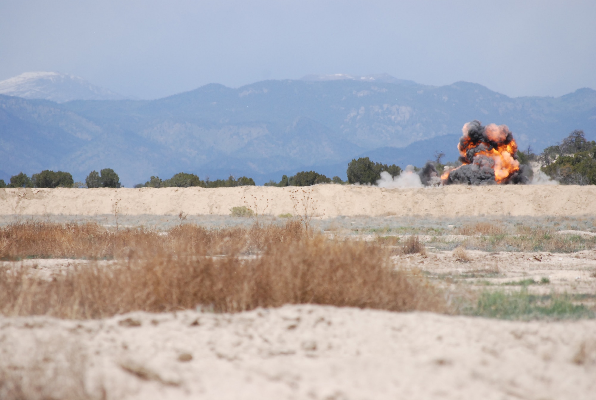 FORT CARSON, Colo. -- Junior explosive ordnance disposal technicians learn first-hand about applying proper stand-off distances and how explosive placement is critical to focusing its destructive power during joint training June 4 at Fort Carson. (U.S. Air Force photo/Michael Golembesky)