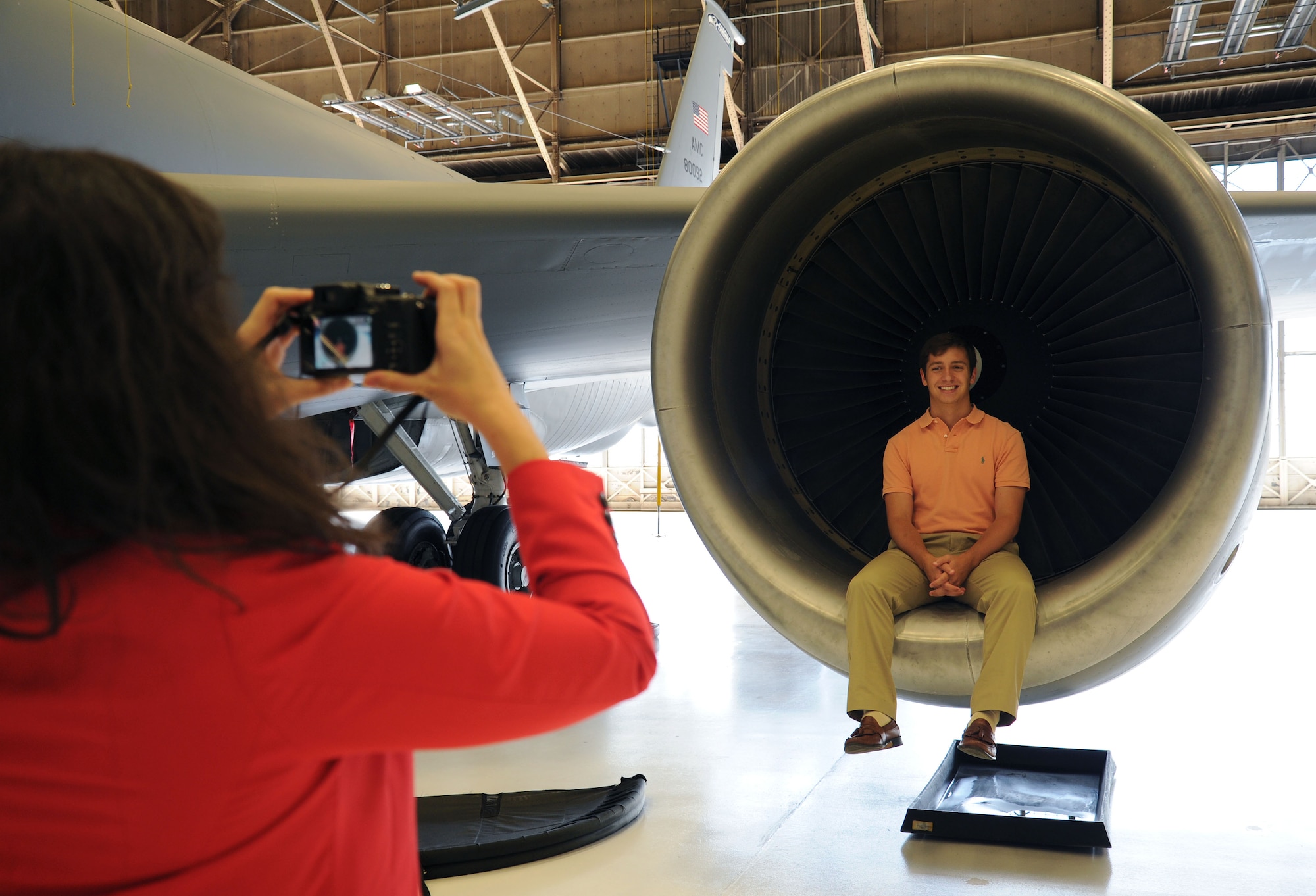 Students from the Society of American Indian Government Employees take photos on a KC-135 Stratotanker engine during a tour at Fairchild Air Force Base, June 4, 2013. Fairchild conducted a base tour which consisted of 20 SAIGE students from all over the country. (U.S. Air Force photo by Airman 1st Class Janelle Patiño/Released)