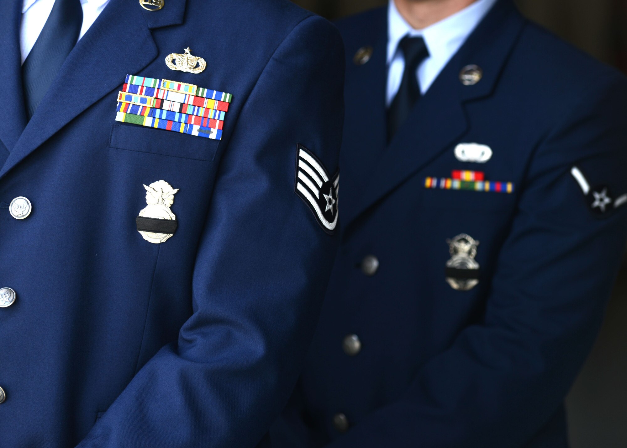 Defenders from the 31st Security Forces Squadron wear a black band over their shield in mourning for Airman 1st Class Dennis A. Felton II, 31st SFS security response team member,  June 11, 2013 at Aviano Air Base, Italy. Felton was killed in a motor vehicle crash which occurred near the base June 2. (U.S. Air Force photo/Airman Ryan Conroy)