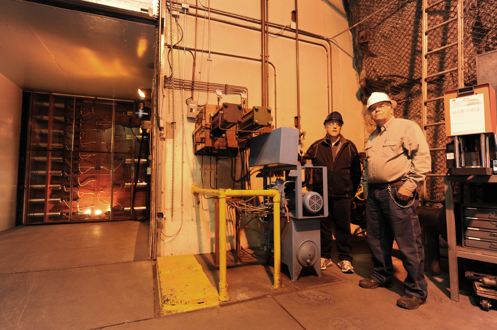 CHEYENNE MOUNTAIN AIR FORCE STATION, Colo. -- Earl Clelland (right), 721st Civil Engineer Squadron power systems mechanic, lets one of his tour group members experience sealing Cheyenne Mountain’s 18-ton maintenance blast door May 9. CMAFS is home to the 721st Mission Support Group, which operates, maintains, secures, sustains, mobilizes, tests, and controls the worldwide warning and surveillance system for North America. (U.S. Air Force photo/Staff Sgt. J. Aaron Breeden)